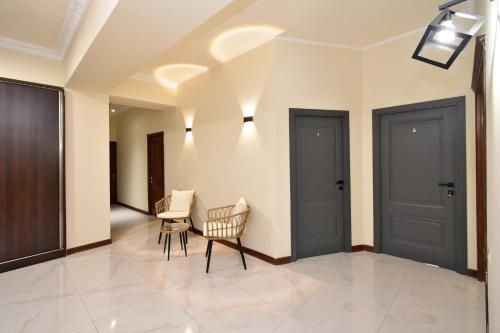 a living room with two doors and a table and chairs at Dreem House in Yerevan