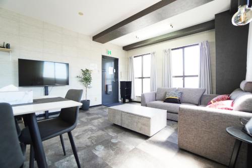 a living room with a couch and a table at Nishiki-en in Osaka