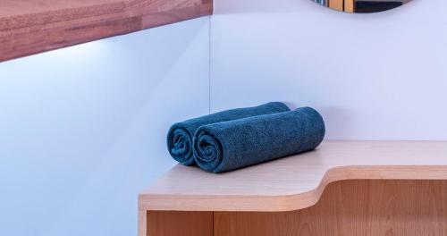 a couple of rolled towels sitting on a counter at CRiB by Bobobox, Kuningan, Jakarta in Jakarta
