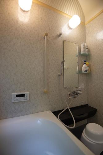 a bathroom with a shower and a toilet at Sobahachi Stay in Nasushiobara