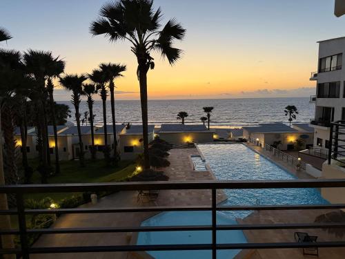 a view from the balcony of a resort with a swimming pool at Relax Ocean Views in Bijilo