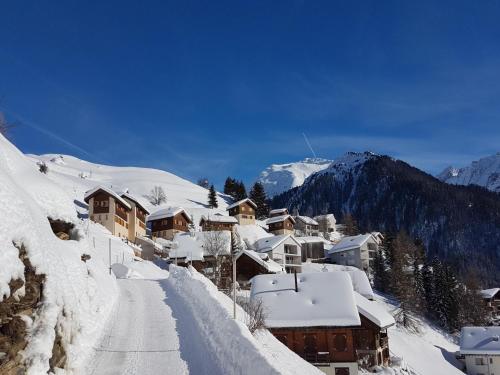 a snow covered village with houses on a mountain at Residence Lahnhof, Laces in Laces