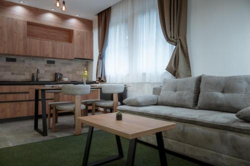 a living room with a couch and a table at Angelina Apart Hotel&Spa in Divčibare