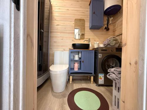 a small bathroom with a washing machine and a washer at Guest House Cholpon-Ata, Aitmatov Street 104-11 in Cholpon-Ata