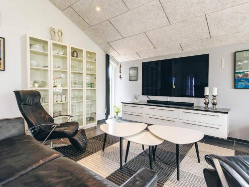 a living room with a couch and a tv at 5 star holiday home in Brovst in Brovst