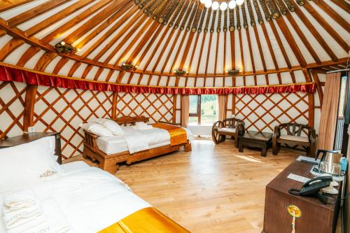 a room with two beds in a yurt at Blue Spot Resort in Yoliin Hural