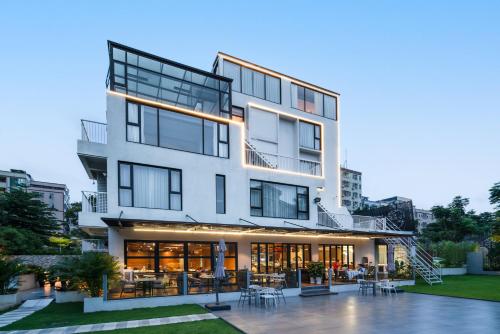 a large white building with a lot of windows at Songshan Lake Minshu Villa 
