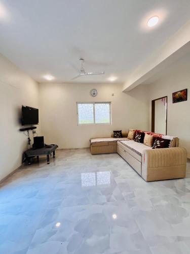 a large living room with a couch and a tv at Krushnai Akshay Villa - Neral in Vangani