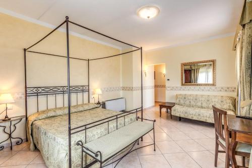 a bedroom with a bed and a table and a desk at Villa Ambrosina in Impruneta