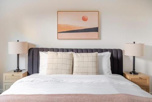 a bedroom with a white bed with two lamps at Blueground Old Mountain View pool nr Park SFO-1876 in San Francisco