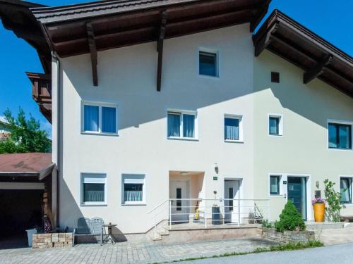a large white house with a balcony at Apartment near Gondola in Tyrol in Holzhamm