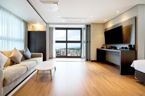 a living room with a couch and a table at The Hotel Sokcho in Sokcho