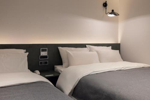Postel nebo postele na pokoji v ubytování Aank Hotel Suwon Station