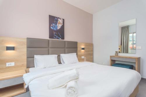 a bedroom with a large white bed in a room at Grey - Elegant Apartments in Awkar in Dbayeh