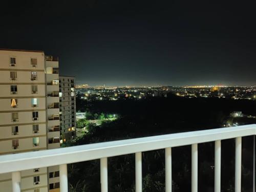 a view of a city at night from a balcony at Studio w pool, mountain city view Mactan airport in Basbas