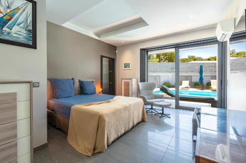 a bedroom with a bed and a view of a pool at La Villa Grazzoso - Piscine Privée in Sainte-Lucie de Porto-Vecchio
