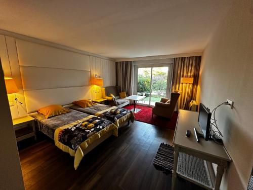 a hotel room with a bed and a desk at Ocean et Golf in Anglet