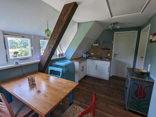 een keuken met een houten tafel in een kamer bij Dat smucke Reethus - OG in Born