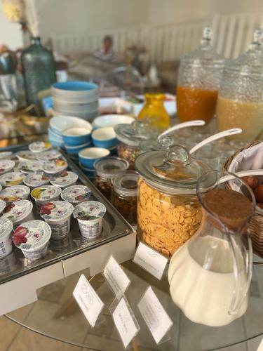 a counter with jars of food and other food items at Hotel Eden in Toscolano Maderno