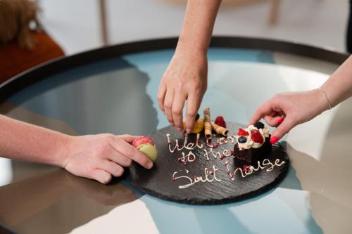 a cake on top of a table with two people at The Salthouse Hotel in Ballycastle