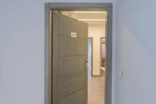 a door with the exit sign on it in a hallway at Grey - Elegant Apartments in Awkar in Dbayeh