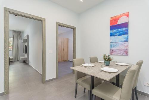 a dining room with a table and chairs at Grey - Elegant Apartments in Awkar in Dbayeh