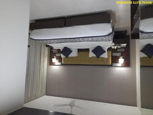 a room with two bunk beds on a wall at Grand Continent Malleshwaram A Sarovar Portico Affiliate Hotel in Bengaluru