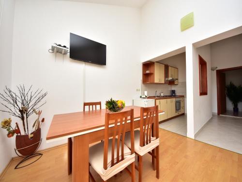 a kitchen and dining room with a wooden table and chairs at Holiday Home in Krusevo with Garden & BBQ in Kruševo