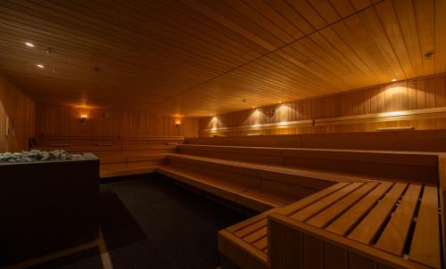 a large empty sauna with wooden benches and lights at Fletcher Wellness-Hotel Leiden in Leiden