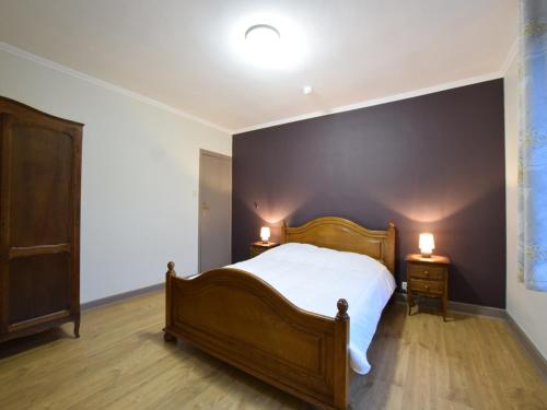 a bedroom with a bed and two lights on two tables at Holiday Home in Gouvy Ardennes with Sauna in Rogery