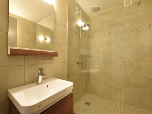 a bathroom with a sink and a shower at Holiday Home in Gouvy Ardennes with Sauna in Rogery