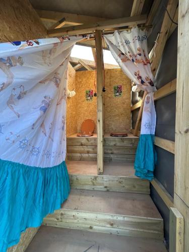 an inside view of a room with a bed and curtains at Luxury Glamping - Heydaze in Lostwithiel