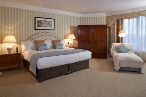 a large bedroom with a large bed and a chair at Cheval Thorney Court at Hyde Park in London