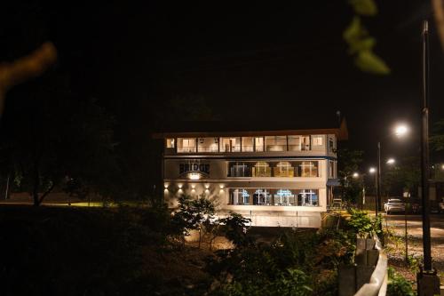 a large building with lights on it at night at The Big Bridge- A Boutique Hotel On A Bridge in Rishīkesh