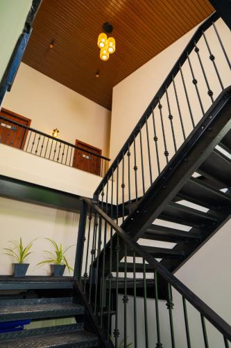 a staircase in a building with potted plants at The Big Bridge- A Boutique Hotel On A Bridge in Rishīkesh