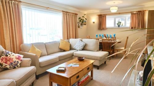 a living room with a couch and a table at Ideal Family Holiday home Exmouth in Exmouth