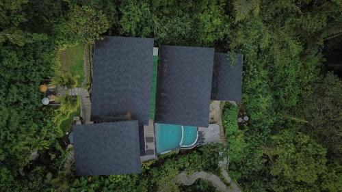 an overhead view of a house with a pool at Alamora Healing Escape in Ubud