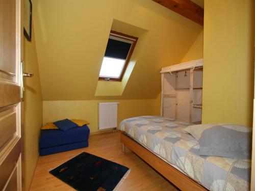 a small bedroom with a bed and a window at Holiday flat on small holiday farm with indoor pool many activities,Kindwiller in Pfaffenhoffen