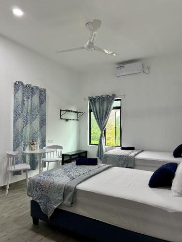 a bedroom with a large bed and a window at Ocean Cottage 2, Radiant Teluk Sari in Kampung Mawar