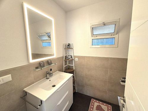 a white bathroom with a sink and a mirror at Casa Eladio - El Morche in Huit