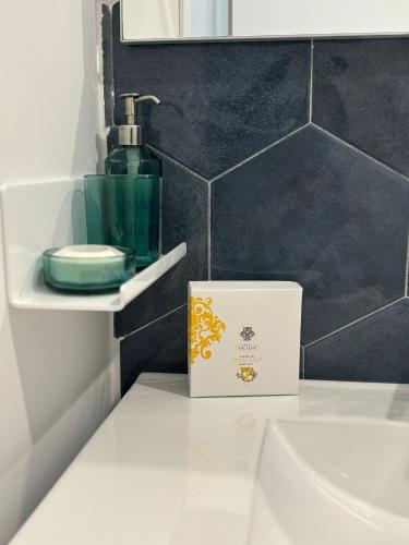 a bathroom with a bottle of soap and a sink at Villa Ragona Taormina in Taormina