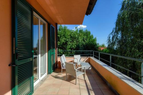 a balcony with two chairs and a table at Villa Marta by Quokka 360 - 15 minutes from the centre of Como in San Fermo della Battaglia
