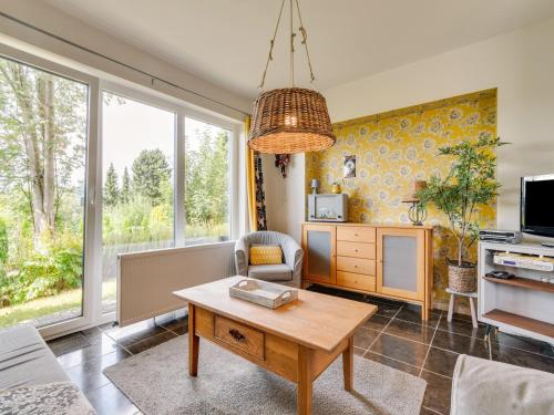 a living room with a table and a tv at Ferienwohnung in der Nähe von Skipisten in Winterberg