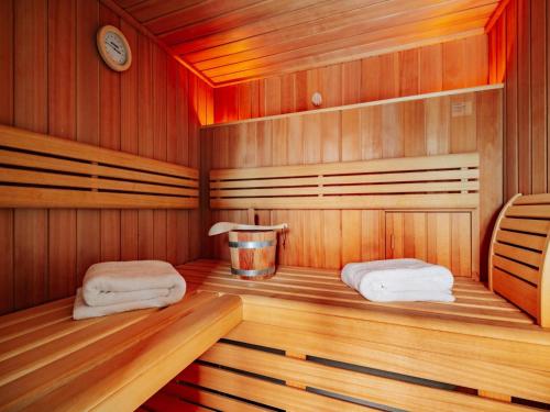 a sauna with two towels on a wooden floor at Semi-detached houses, turf house in Torfhaus
