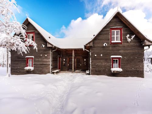 a log cabin in the snow with snow on the ground at Semi-detached houses, turf house in Torfhaus