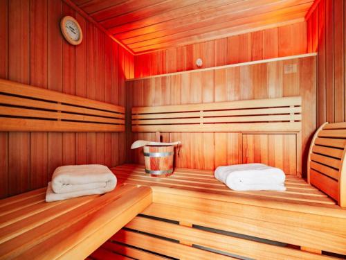a sauna with two towels on a wooden floor at Semi-detached houses, turf house in Torfhaus