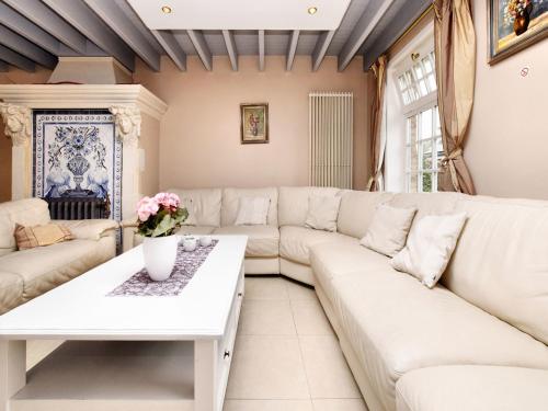 a living room with a white couch and a table at Durbuy Luxe Villa with Pool in Petite Somme