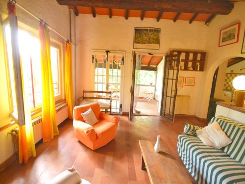 a living room with two couches and a table at Holiday Home with Garden and shared pool in Migliorini
