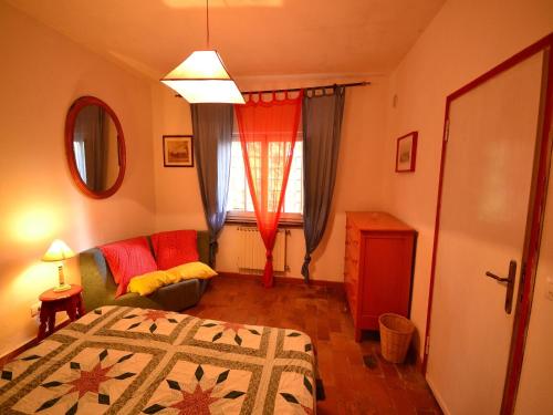 a bedroom with a bed and a couch and a window at Holiday Home with Garden and shared pool in Migliorini