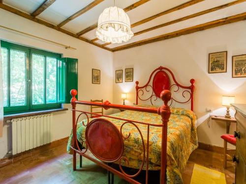 a bedroom with a bed and a chandelier at Holiday Home with Garden and shared pool in Migliorini